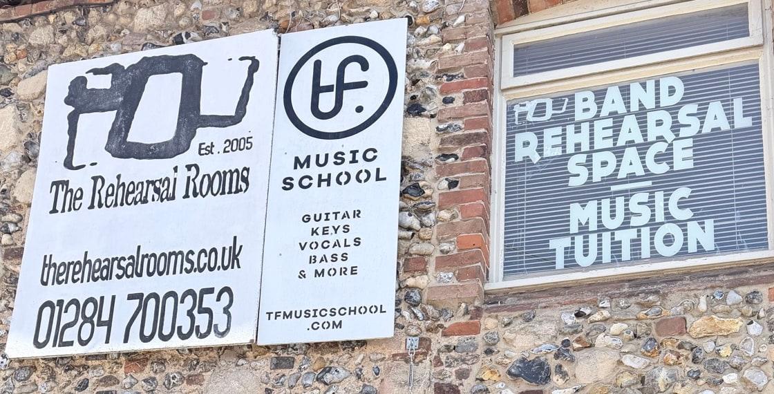 Clear Rehearsal Rooms signage for arrival confidence.