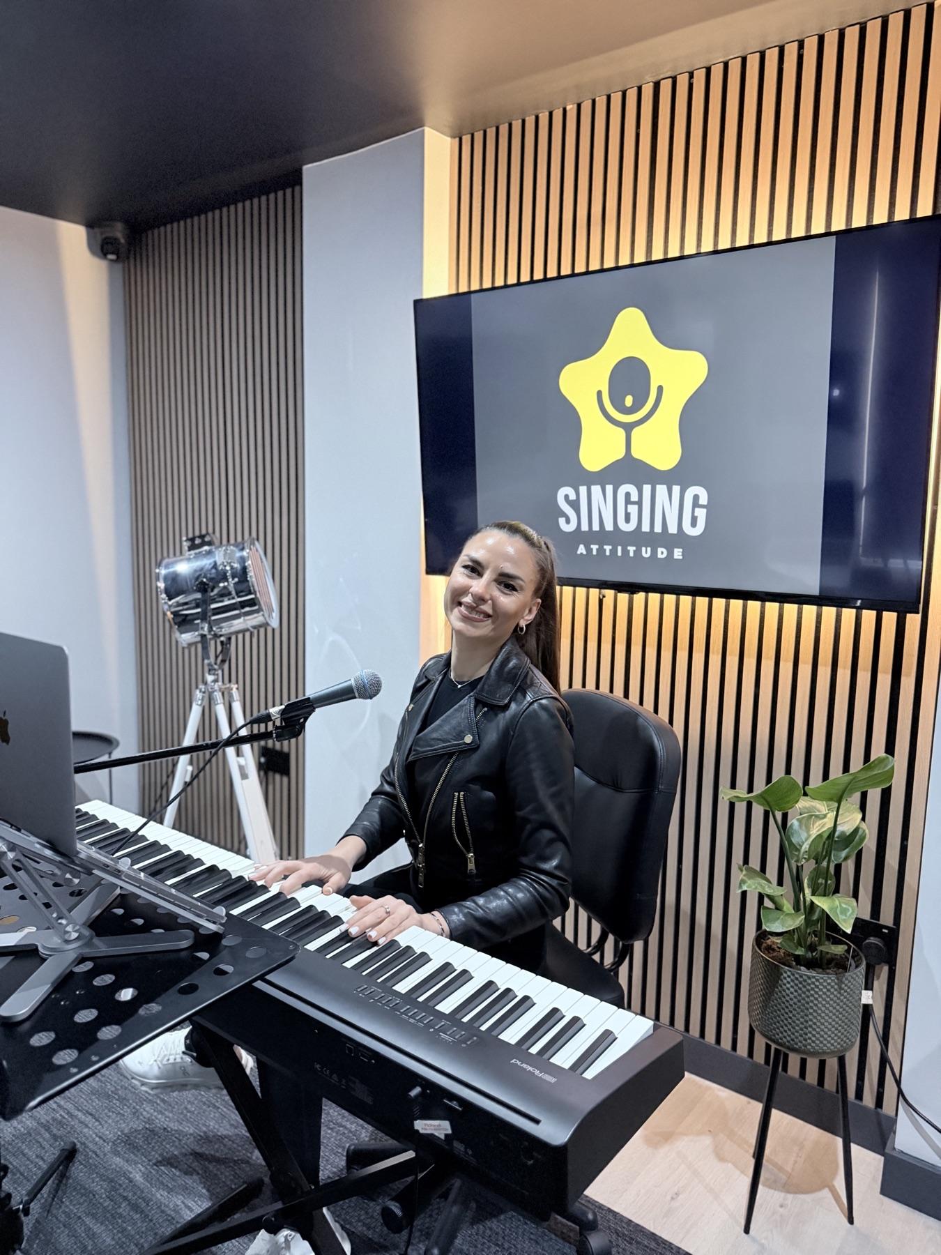 Liuba Doga at Ely Studio with a keyboard and Singing Attitude screen